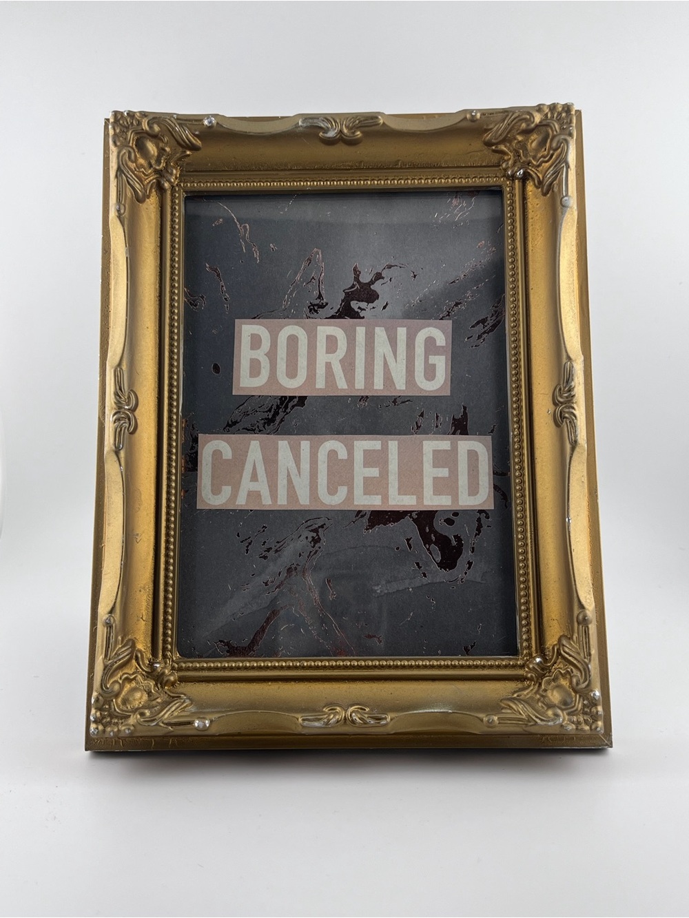 Gold Ornate Picture Frame with 'Boring Canceled' Art